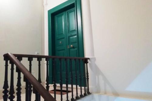 a green door on the side of a stairs at Nuvoleinviaggio in Sulmona