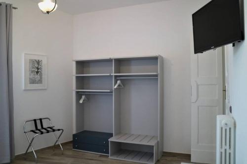 a room with a book shelf and a tv at Nuvoleinviaggio in Sulmona