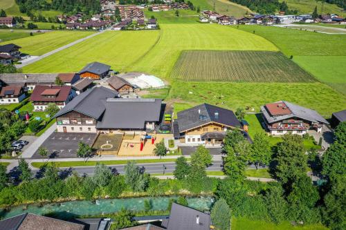 an aerial view of a town with houses and a field at Bauernhof Vorderklinglhub &Landhaus Olga in Flachau