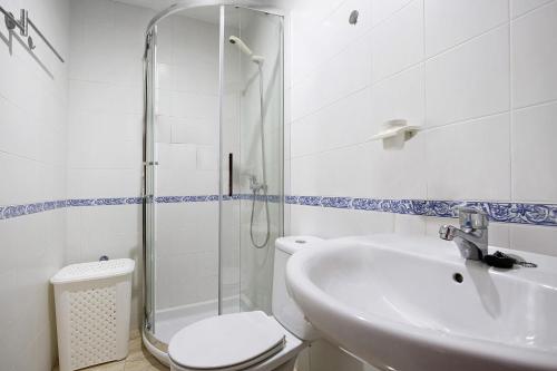 a bathroom with a toilet and a sink and a shower at Apartamento Betty G in Puerto del Rosario