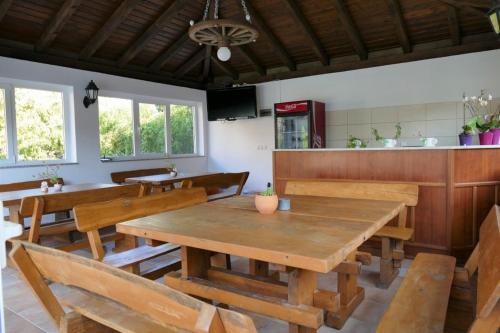 a dining room with a wooden table and chairs at Apartment in Mundanije with balcony, air conditioning, WiFi (4912-1) in Mundanije