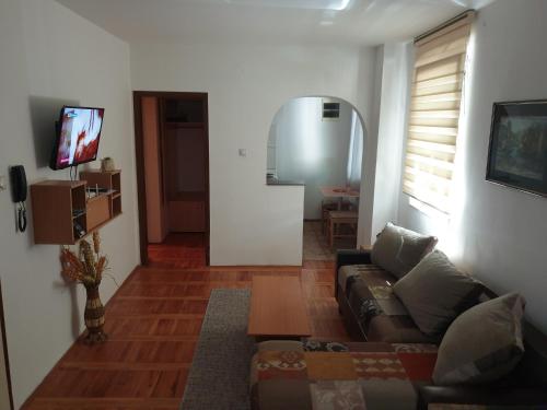 a living room with a couch and a table at city center apartment 1 in Niš
