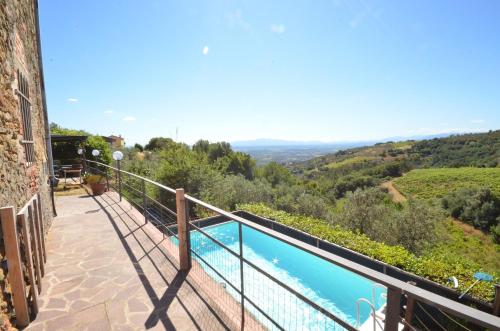 a balcony with a view of a swimming pool at Casa Mela in Vinci