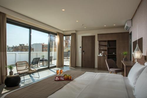 a bedroom with a bed with a tray of fruit on it at Metropole Urban Hotel in Heraklio Town