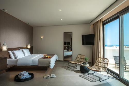 a hotel room with a bed and a balcony at Metropole Urban Hotel in Heraklio