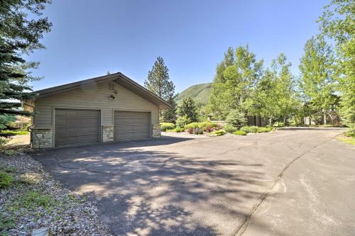 a house with a garage on a driveway at West Glacier Home with Majestic Mountain Views! in West Glacier