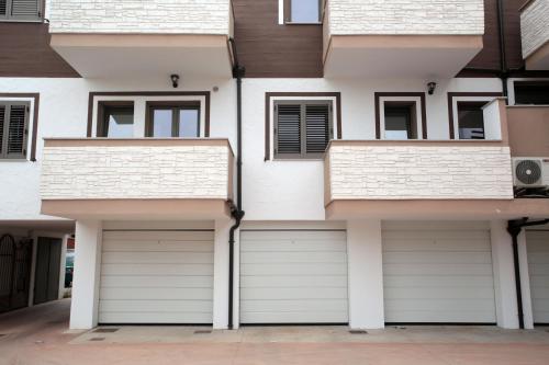 two garage doors on the side of a building at Casa Kant in SantʼAntìoco