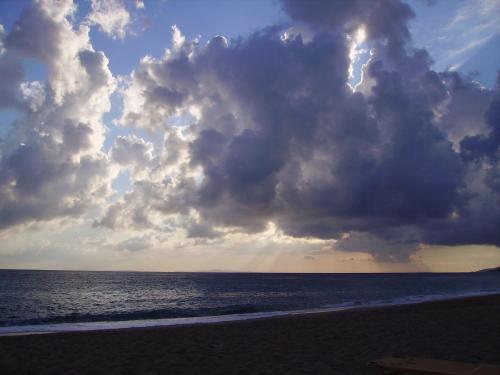a cloudy sky over a beach with the ocean at Hotel Loukas Vrachos in Paralia Vrachou