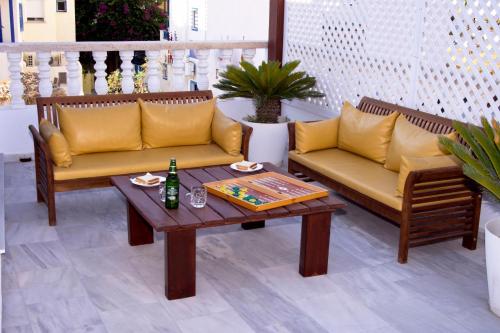 a patio with two couches and a coffee table at Black Sandy Beach in Perissa