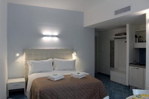 a bedroom with a bed with two towels on it at Divina Holiday - Apartments in Maiori
