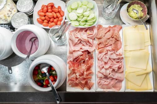 a bunch of different types of food on a counter at Feichter Hotel & Bistro in Bolzano