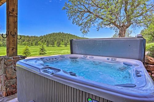 a hot tub sitting on a patio with a tree at Sturgis Home with Private Hot Tub Golf and Hike! in Sturgis