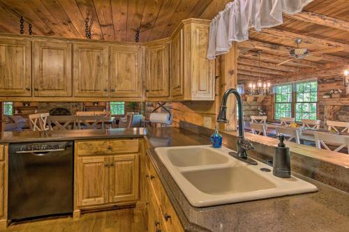 a kitchen with a sink and a stove at Secluded Cabin with Spacious Kitchen and Dining Area! in Sunset