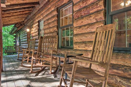 a row of chairs on the porch of a log cabin at Secluded Cabin with Spacious Kitchen and Dining Area! in Sunset