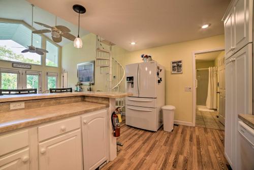 a kitchen with a white refrigerator in a room at Kentucky Lake House with a Great Outdoor Space! in Gilbertsville