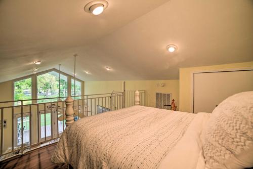 a bedroom with a bed and a balcony at Kentucky Lake House with a Great Outdoor Space! in Gilbertsville