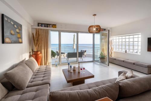 a living room with a couch and a table at Ierapetra Seaview in Ierapetra