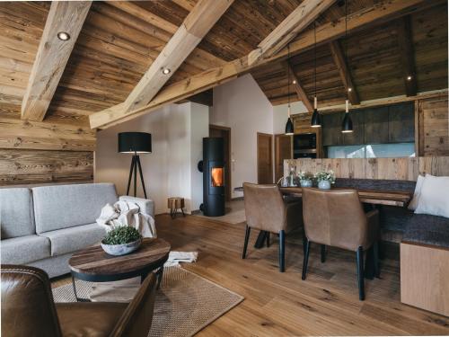 a living room with a couch and a table at VAYA Fieberbrunn inklusive Gästekarte in Fieberbrunn