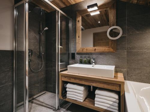 a bathroom with a sink and a shower at VAYA Fieberbrunn inklusive Gästekarte in Fieberbrunn