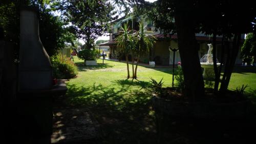 a house with a yard with trees and a yard sidx sidx sidx at Villa Isabella in Marina di Grosseto