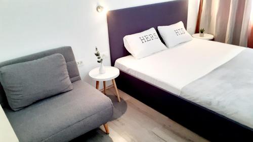 a small bedroom with a bed and a chair at Ani 2 in Gradac