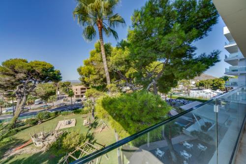an apartment balcony with a view of a park at Playa Esperanza Resort Affiliated by Meliá in Playa de Muro