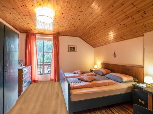 a bedroom with two beds and a wooden ceiling at Appartements Gabrielli Sophie in Trodena