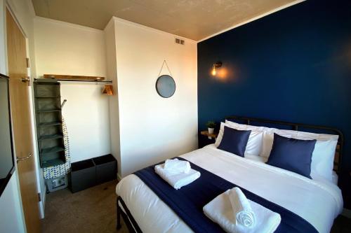 a bedroom with a large bed with blue walls at Middlehaven Apartment in Middlesbrough