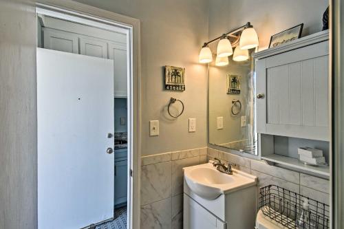 a white bathroom with a sink and a mirror at Oceanfront Resort Studio on Virginia Beach! in Virginia Beach