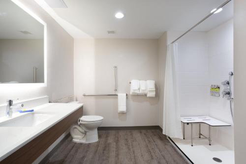 a white bathroom with a toilet and a sink at Holiday Inn Express & Suites - Morehead City by IHG in Morehead City