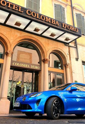 a blue car parked in front of a colombiaodo store at Hotel Colomba d'Oro in Verona