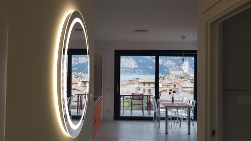 a room with a mirror and a table with a view at Blue Sky Garda - Sunset in Malcesine