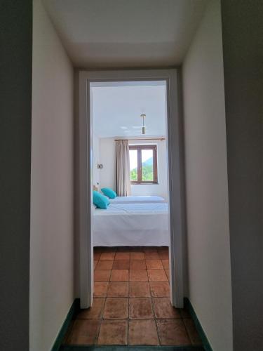a doorway to a bedroom with a bed and a window at Casa Fifina Rooms in Sant'Egidio del Monte Albino