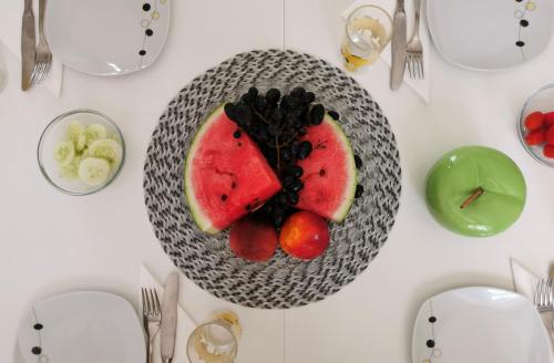 a plate of fruit on a white table at Apartments Lošotovi Vrboska in Vrboska