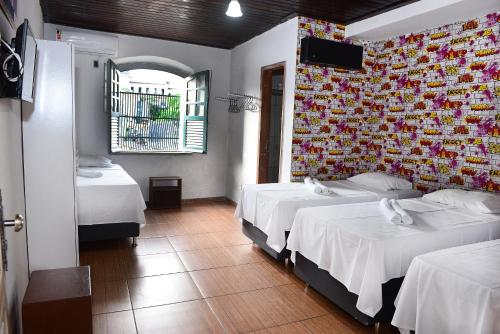 Кровать или кровати в номере Pousada Cor e Arte - Pelourinho