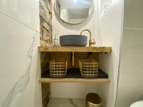 a bathroom with a sink and a mirror at Studio d'architecte centre historique in Ajaccio