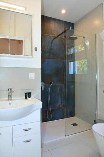 a bathroom with a sink and a shower at BLUE SKY COTTAGE, Kanouli beach in Halikounas