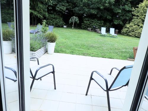 a group of chairs sitting on a patio at Ailes et Iles in Pleudaniel