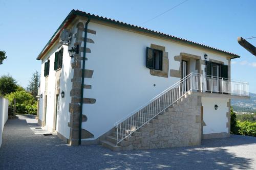 a building with a staircase on the side of it at Casa Do Tio Arménio in Ponte de Lima