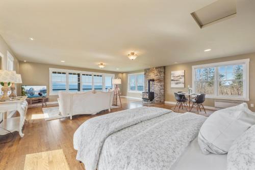 a bedroom with a large bed and a table and chairs at @ Marbella Lane - Waterfront Studio Whidbey Island in Coupeville