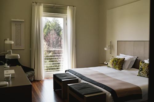 a bedroom with a large bed and a window at M'AR De AR Aqueduto in Évora