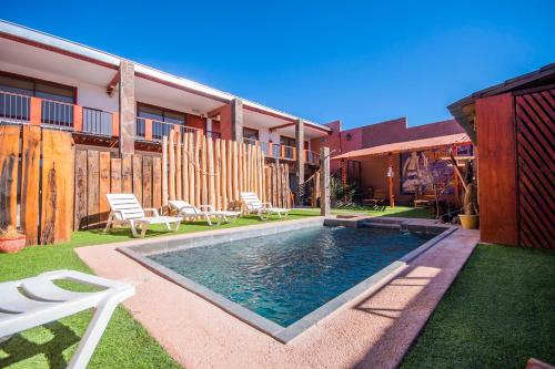 a swimming pool in the backyard of a house at Hotel Casa Algarrobo in San Pedro de Atacama