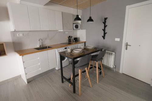 a kitchen with a table and chairs and a sink at Estudio Morella in Morella