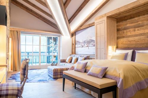 a bedroom with a large bed and a large window at Alpin Resort Sacher in Seefeld in Tirol