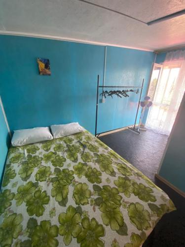 a bedroom with a bed with a green comforter at Номера в Фонтанке in Fontanka