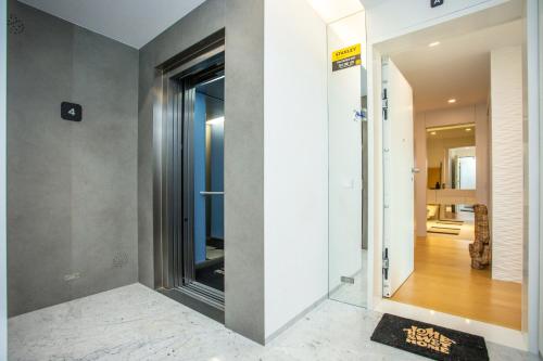 a hallway with a glass door leading to a room at Acqua House by Rent4All in Figueira da Foz