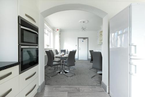 a kitchen and dining room with a table and chairs at KVM - Sugar Way House in Peterborough