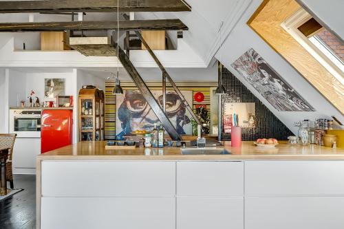 a kitchen with white cabinets and a counter top at Gormsgade lejlighed in Jelling