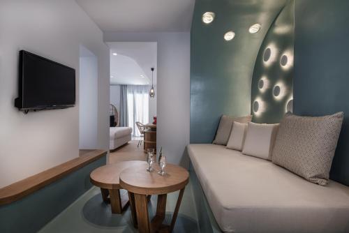 a living room with a couch and a table at Argo Boutique Hotel in Naxos Chora