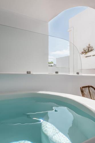 a swimming pool with blue water in a room at Argo Boutique Hotel in Naxos Chora